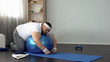 © motortion - Chubby man resting after workout, lying on fitness ball, desire to lose weight