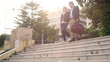 © motortion - Happy couple with bags leaving hotel and going downstairs, vacation travel