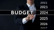 © motortion - 2024 budget, businessman selects file on virtual screen, annual financial report