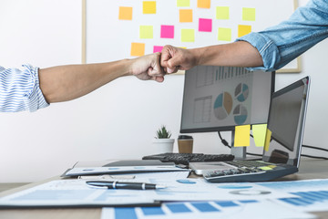 Wall Mural - Teamwork of businesspeople partnership giving fist bump to greeting start up business strategy project