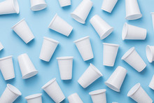 Single Use White Plastic Cups On A Blue Background