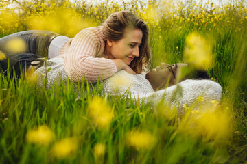 Wall Mural - young couple lying on the high grass