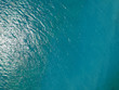 Aerial top view water surface background. Bird eye sea surface photo. Blue ocean from above. Minimal.