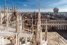 Top View From The Roof Of Duomo Di Milano Cathedral With Marble Statues To The City And The Royal Palace Palazzo Reale On Piazza Del Duomo Square. Milan, Italy.
