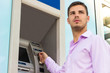 © sanjagrujic - Young businessman withdrawing money from a cash machine