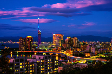 Sticker - A sunset with a view of central Fukuoka, Japan, with tall modern buildings