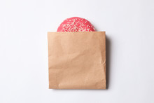 Paper Bag With Glazed Doughnut On White Background, Top View. Space For Design