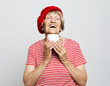 © Raisa Kanareva - old excited lady smiling laughing, holding cup drinking coffee