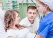 © Ermolaev Alexandr - a nurse checks the health of a pregnant woman before giving birth in an operating room