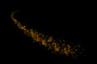 Gold glitter particles lights trail and bokeh on a black background. Abstract line sparkle texture.