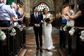 Newly wed couple walking down the aisle