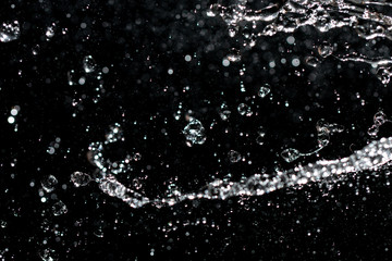  water jet with splashes on a black background