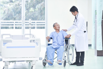 The patients in the hospital were happy holding the caregiver's hands while spending time together.