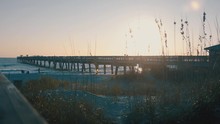 A View Of The Jacksonville Beach Pier From A Boardwalk At Sunrise