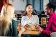 © zinkevych - Three friends eating delicious salads in their favorite restaurant