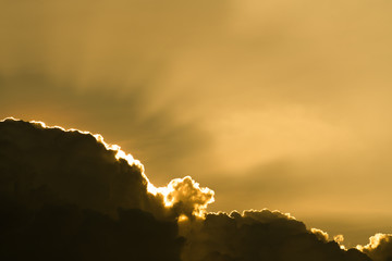 Sun rays through clouds like an dramatic explosion , power nature background.