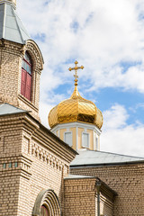 Beautiful white church with golden domes on a blue sky background