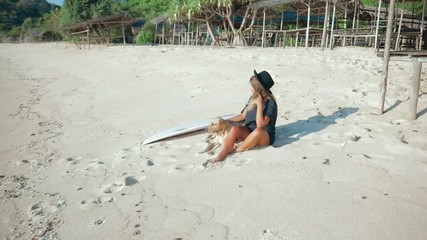 Wall Mural - young surfer woman with surfboard and dog