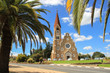 Windhoek, Namibia - April 15, 2015: The classic German Lutheran Church of Christ in Windhoek in the setting of palm trees. One of the main attractions of the city.