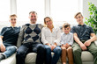 © Louis-Photo - A Beautiful happy family sit on sofa at home