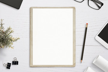 Poster - Empty paper mockup, on old folder, white wooden work desk. Top view, flat lay.