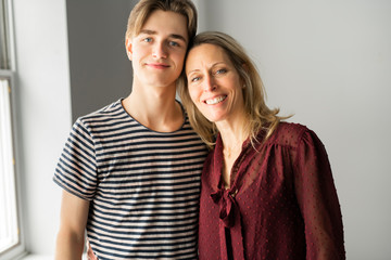 A people and family happy teen boy with mother at home