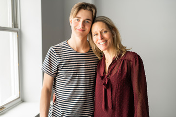a people and family happy teen boy with mother at home