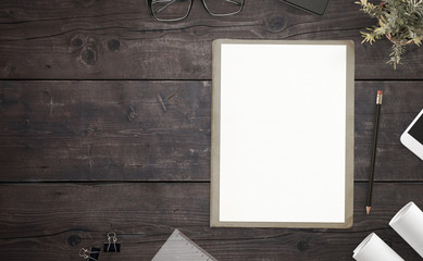 Poster - Paper on wooden desk with copy space beside. Top view, flat lay coposition.