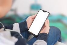 Boy Holding Smart Phone With Isolated, Blank, White Screen For Mockupp, App Or Web Site Presentation. Close-up, Isometric View.