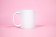 White coffe mugs on pink background 