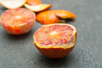 Wall Mural - peeled blood oranges on dark wood table