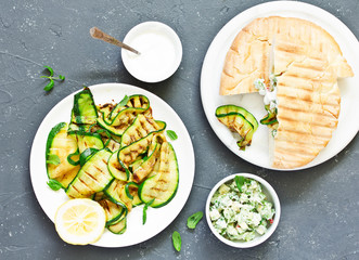 Wall Mural - Grilled zucchini with sauce and pitta. view from above. Selective focus.