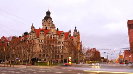 Wall Mural - Leipzig, Germany. View of New Rathaus in Leipzig, Germany at sunset. Time-lapse of car traffic lights with cloudy evening sky, zoom in