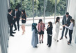 © InfiniteFlow - Many business people gathering in modern office building for business conference in the city. Businessmen and businesswomen communication and human resources concept.