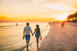 © Maridav - Beach summer beach people lifestyle happy couple enjoying sunset walk on Shelling beach famous tourist destination on the southwest coast of Florida -Gulf of Mexico. Sanibel Island, Florida.