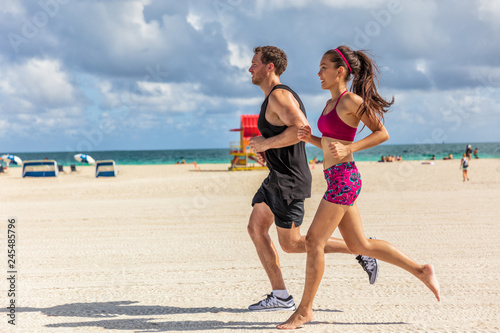 Running People Jogging Exercising On South Beach Miami Florida On South Beach Miami Florida