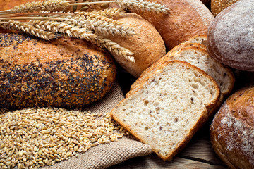 heap of fresh baked bread on wooden background