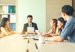 © kittipong - Teamwork business concept .Start up business people in modern office, working together having success. Multiethnic start-up business team on meeting in modern bright office interior brainstorming