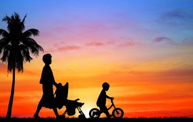 Wall Mural - silhouette happy  family on the beach at  sunrise time