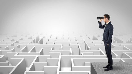 Wall Mural - businessman standing on maze and looking forward to the future concept