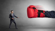 © ra2 studio - Little man fighting with a giant red boxing glove