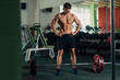 © chrisgraphics - Young fit man resting between exercises in the gym