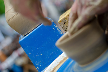 Street master class on modeling of clay on a potter's wheel In the pottery workshop