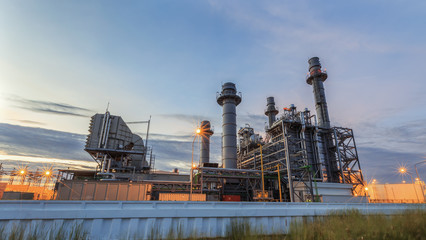 Wall Mural - Gas turbine electrical power plant at dusk with twilight sky