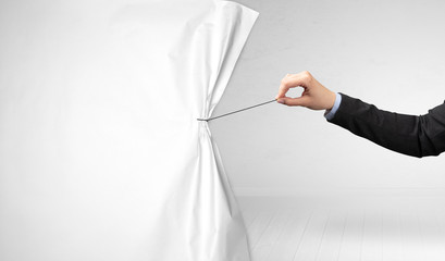 hand pulling white paper curtain, changing scene concept