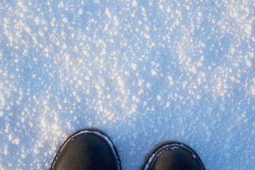 Men's legs in vintage leather boots on the frozen lake