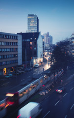 Wall Mural - Morning blue hour shot of a cityscape with tram train and street view with skyline in the background. Köln, Cologne in Germany