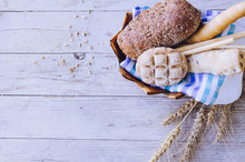 Assortment Of Baked Bread On Wooden Table Background