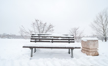 Wooden Bench And Concrete Garbage Or Junk Can On The Street Or In The Park Covered With Snow In The Winter Season