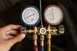 portrait of a mechanic hand uses a pressure gauge to know a function of dynamo